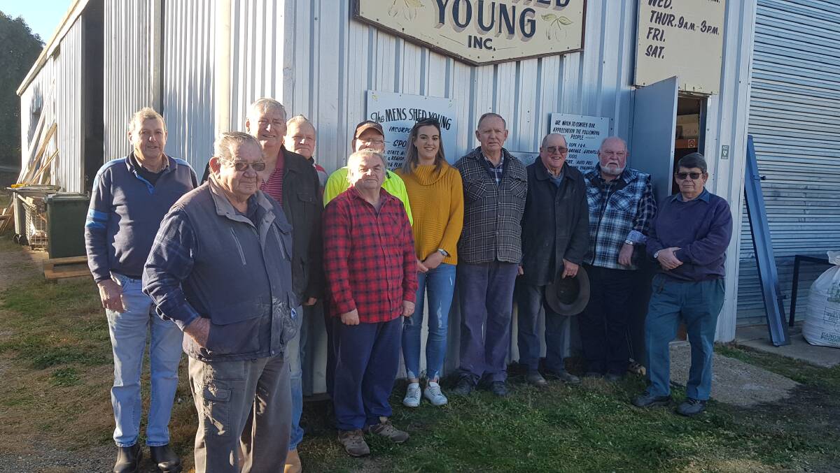 Kate Cruickshank with members of the Young Men's Shed. Kate will be raising funds for the shed as she vies for the title of Cherry Queen.
