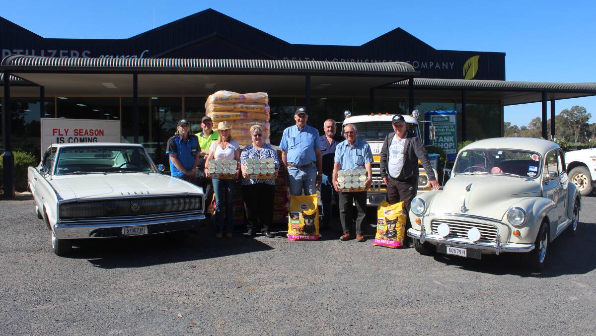 Paul Andrew, Glenn Brooks, Ursula Andrew, Kerry Quin, Brian Tomkins, Greg Russell, Con Bunnik and Colin Dunne with the dog food donation.