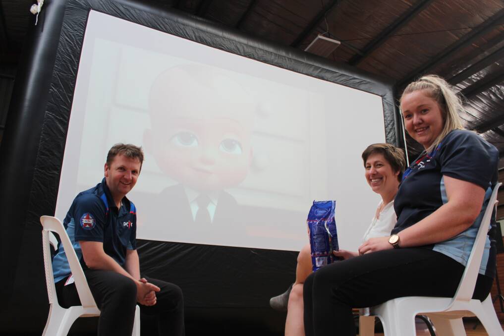 Stewart Mead, Linda Carne and Natalie Clarke test out the club's new screen and projector.