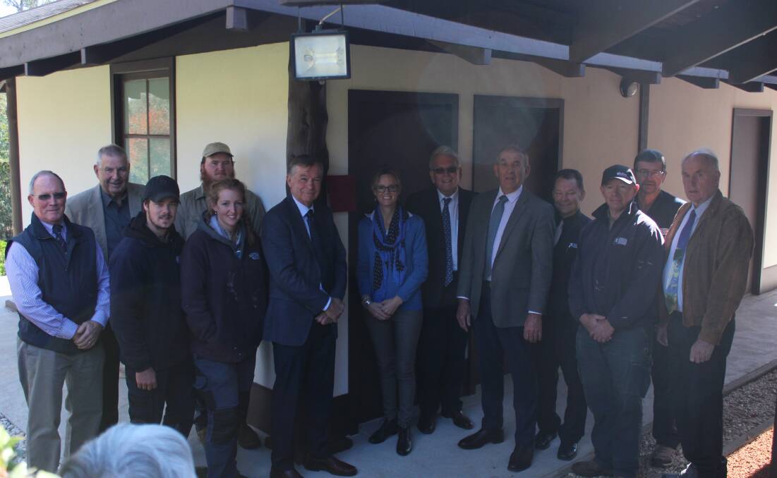 Chair Bob Griffiths and member for Cootamundra Steph Cooke (centre) with mayor Bill West and members of the Japanese Garden board and garden workers.