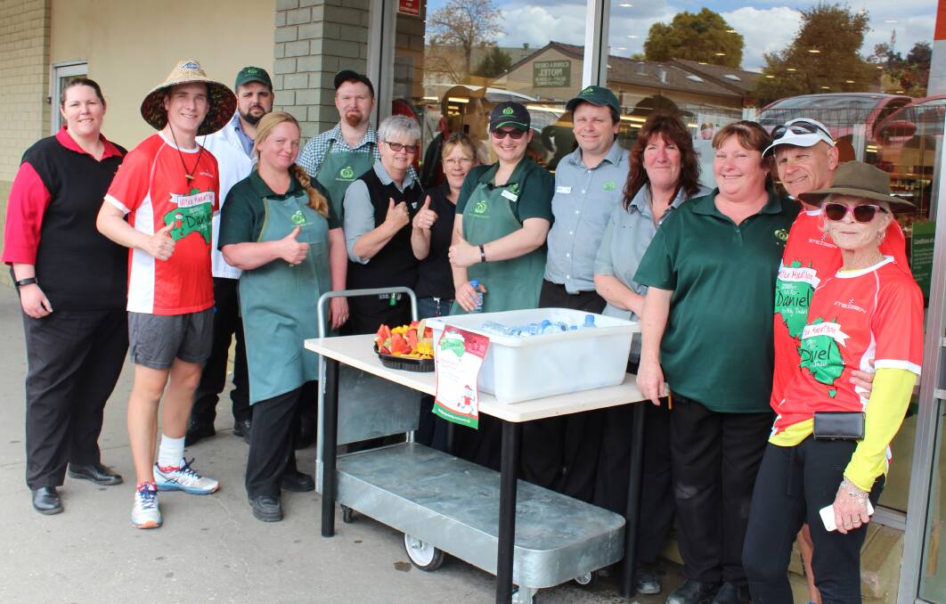 Billy Tindall (second from left) takes a quick break from his ultra marathon with staff from Cowra Woolworths.