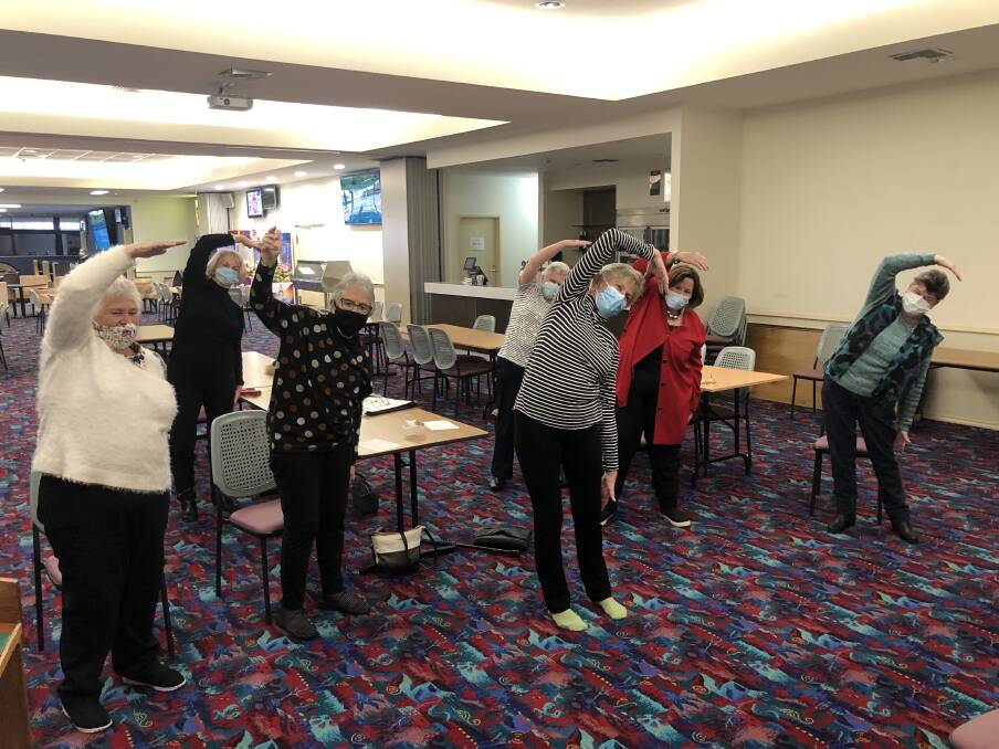 Trish Bowler (center front) leads members of the Arthritis Support Group through some exercises.