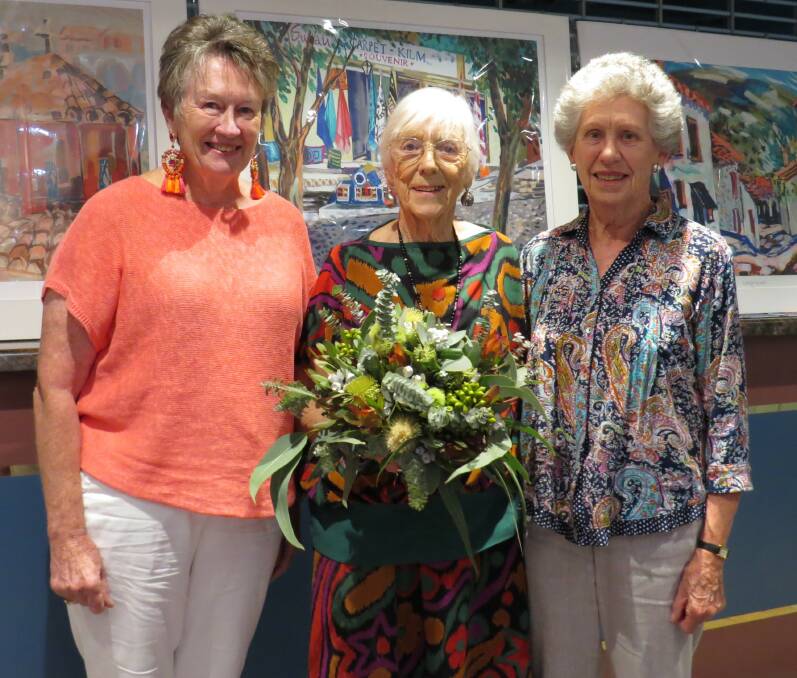 Rowena Casey, Ada Clark and Pam Whitney pictured in front of some of Ada's paintings. 