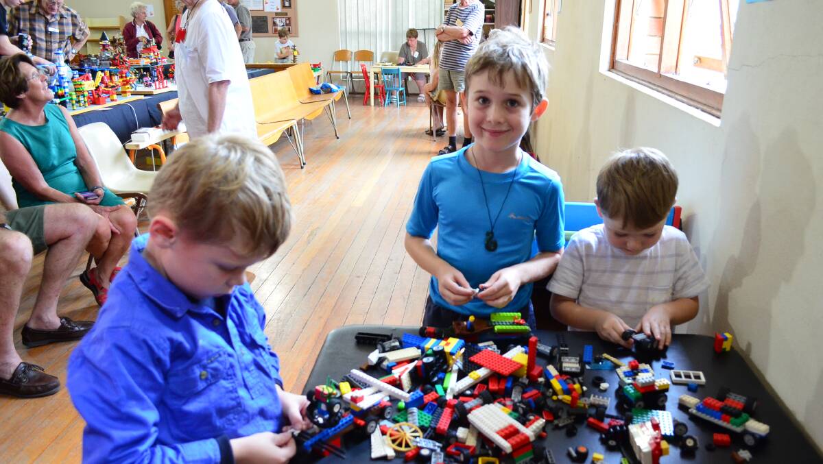 Jack Galvin, Leuwin McGill and Ted Galvin have a go at last year's Lego exhibition.