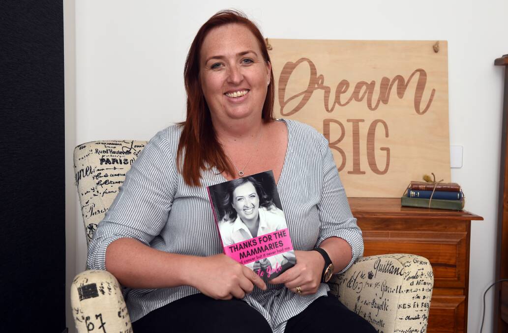 HELPING: Kate Gale with her book Thanks for the Mammaries: I had cancer but it never had me. Picture: Kate Healy