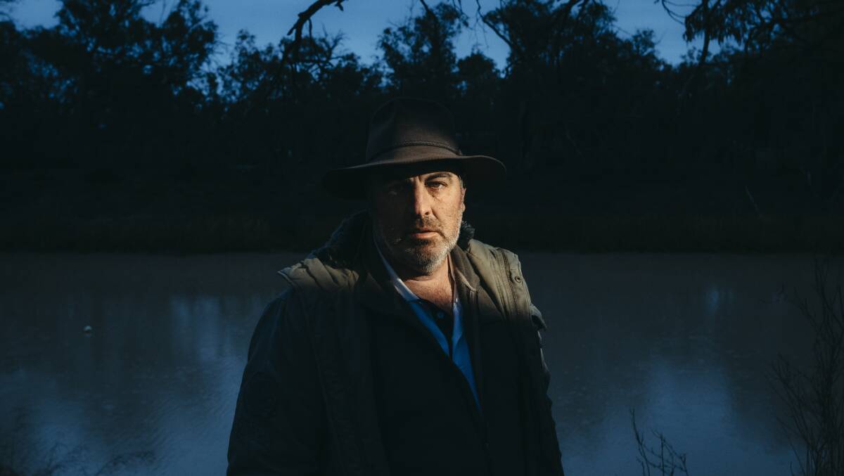 Grape grower Graeme McCrabb stands beside the Darling River where he first saw the fish deaths, at his property in Menindee, NSW. Picture: Dion Georgopoulos