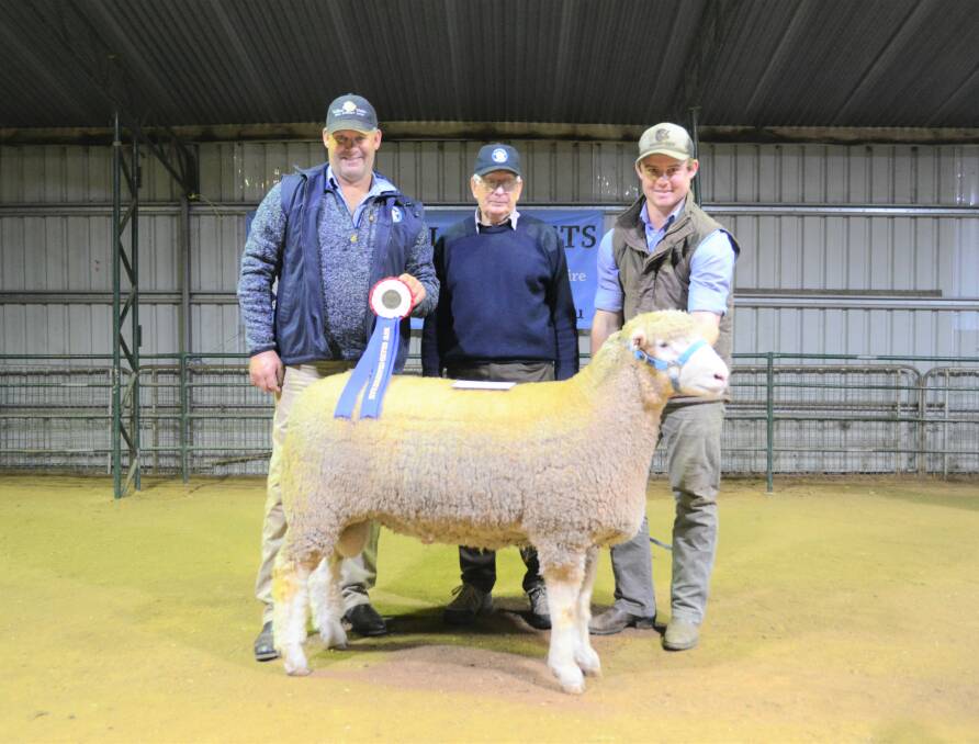 Tough competitors: Andrew Scott and his son, James, 'Valley Vista', flank the judge, Julian Iles, after taking out the Grand Champion Poll Dorset Ram in 2018. Photo: File.