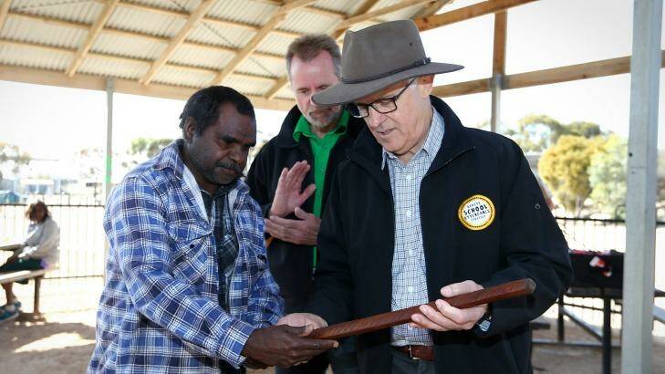 Prime Minister Malcolm Turnbull and Indigenous Affairs Minister Nigel Scullion receive gifts after a visit to the Yalata Anangu School  in South Australia. Photo: Alex Ellinghausen