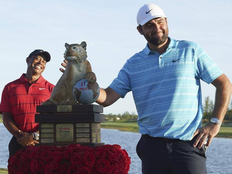 World Hero Challenge winner Scottie Scheffler with the trophy, as Tiger Woods looks on. (AP PHOTO)