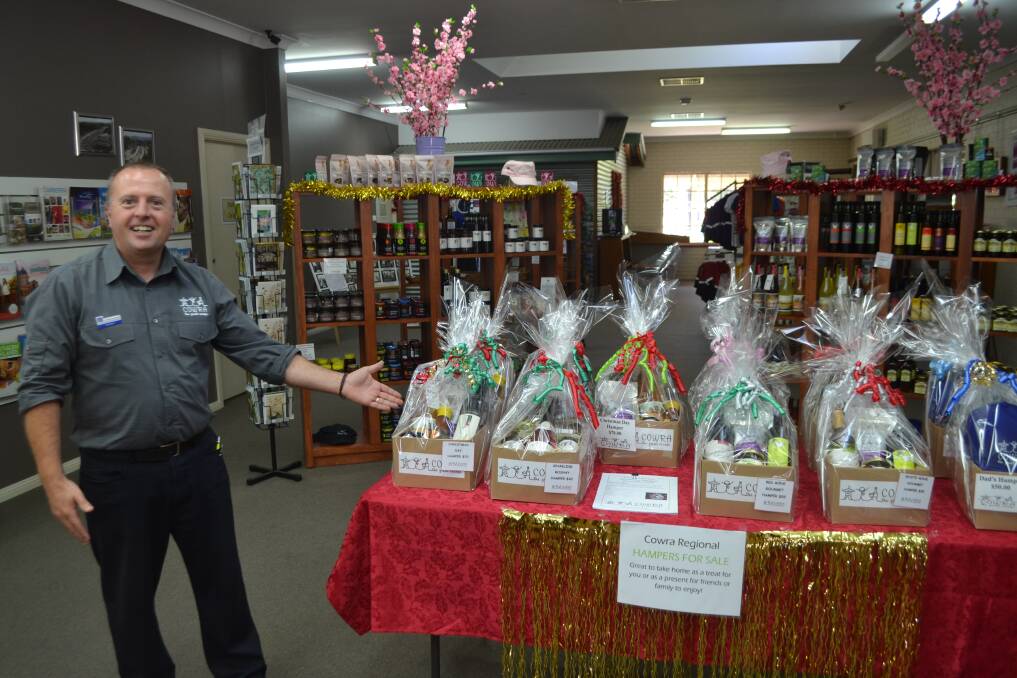 Cowra Tourism Information Officer Andrew Grinter with a variety of Christmas Hampers