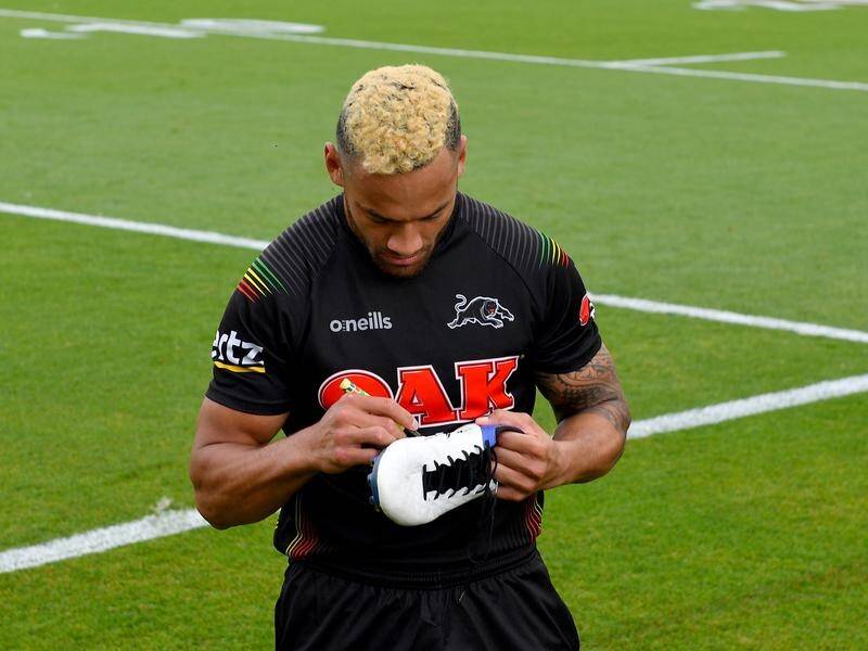 Api Koroisau signs his boots for supporters at an open Panthers training session and fan day.