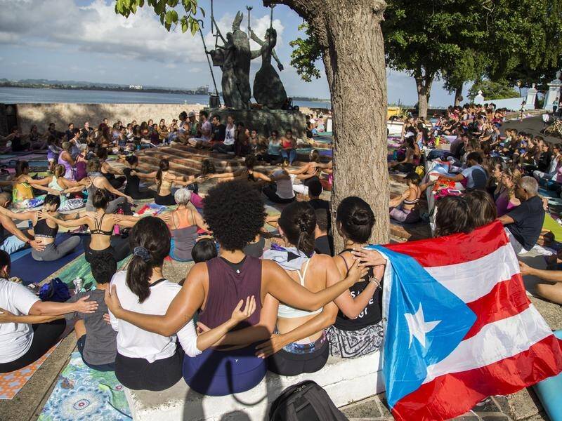 Thousands of Puerto Ricans have protested against the governor over an obscenity-laced online chat.
