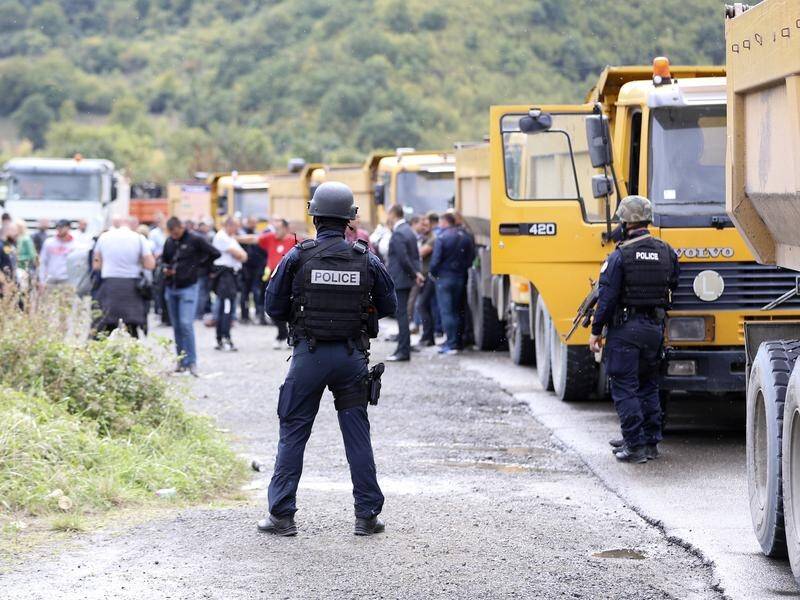 Serbs from Kosovo's north have blocked two main roads near the border to protest a government ban.