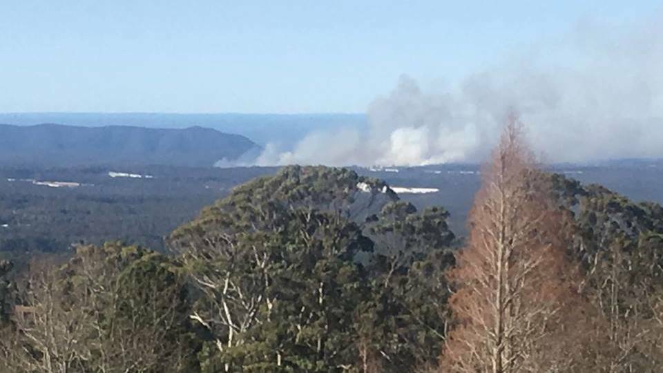 BLAZE: View of the out-of-control bushfire at Bilpin in the Blue Mountains, as seen from Mount Tomah Botanical Gardens. Photo: TRINA LORD