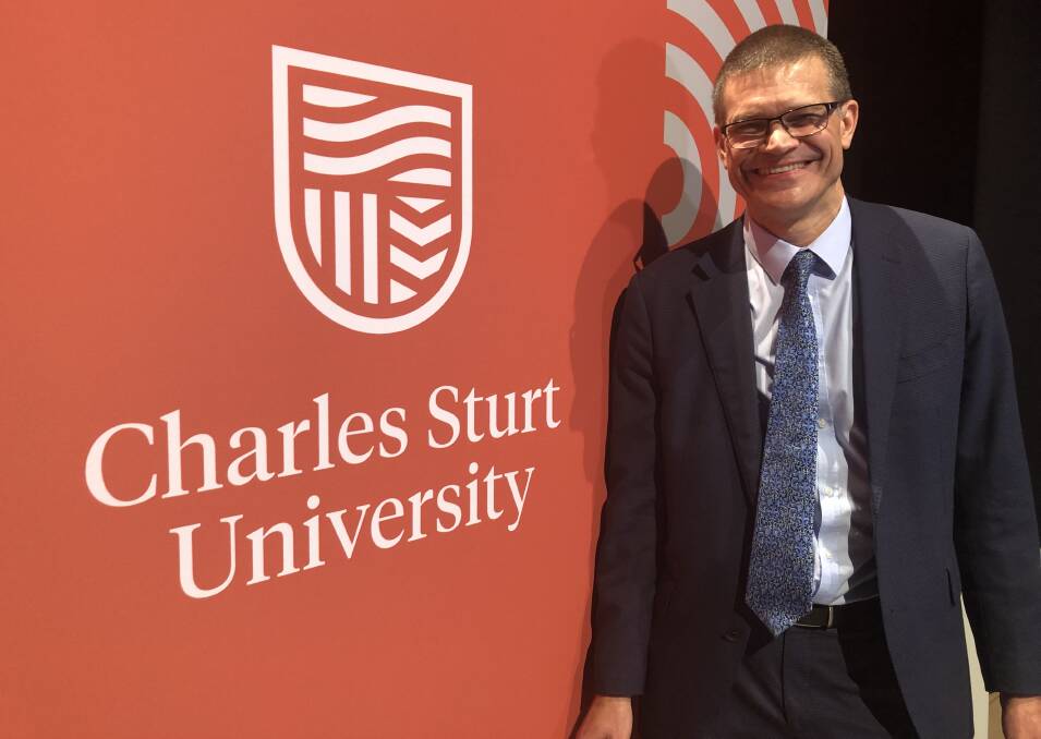 NEW LOOK: Charles Sturt University vice-chancellor Professor Andrew Vann with the new university logo. Picture: DAINA OLIVER 050119csu