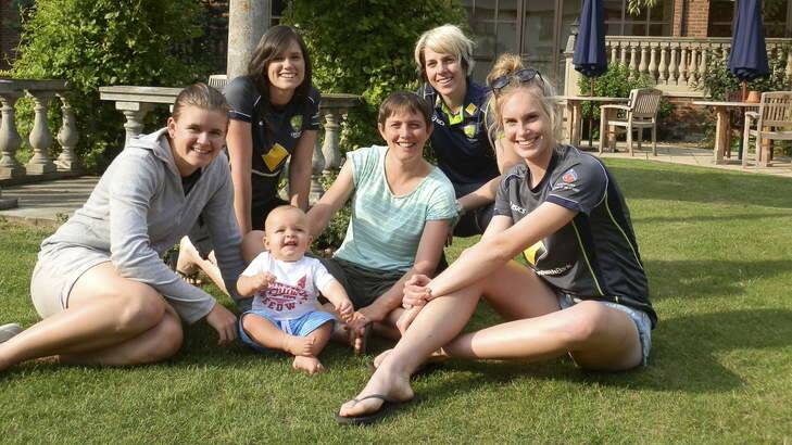 Holding the baby: Australia's Ashes stars enjoy some sun. From left, Jess Jonassen, Gemma Triscari, Sam and Sarah Elliott, Elyse Villani and Holly Ferling. Photo: Supplied