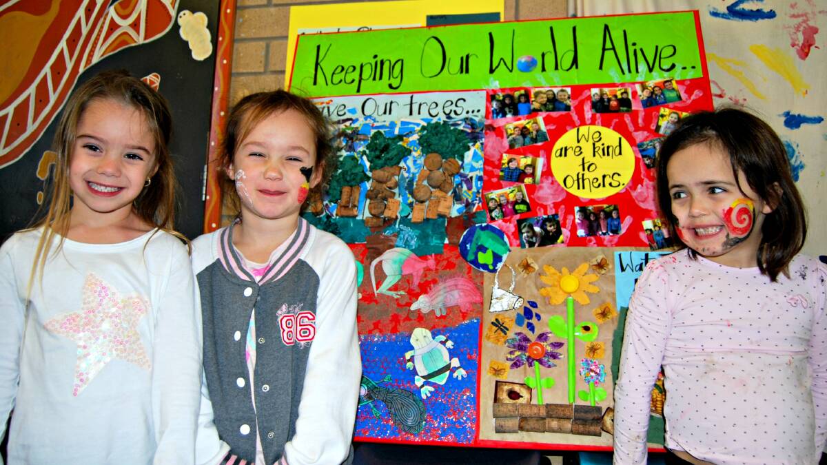 Jada Hardy, Allierira Williams and Mani-Rose Newton proudly display their recycled artwork from the three to five years room. 
