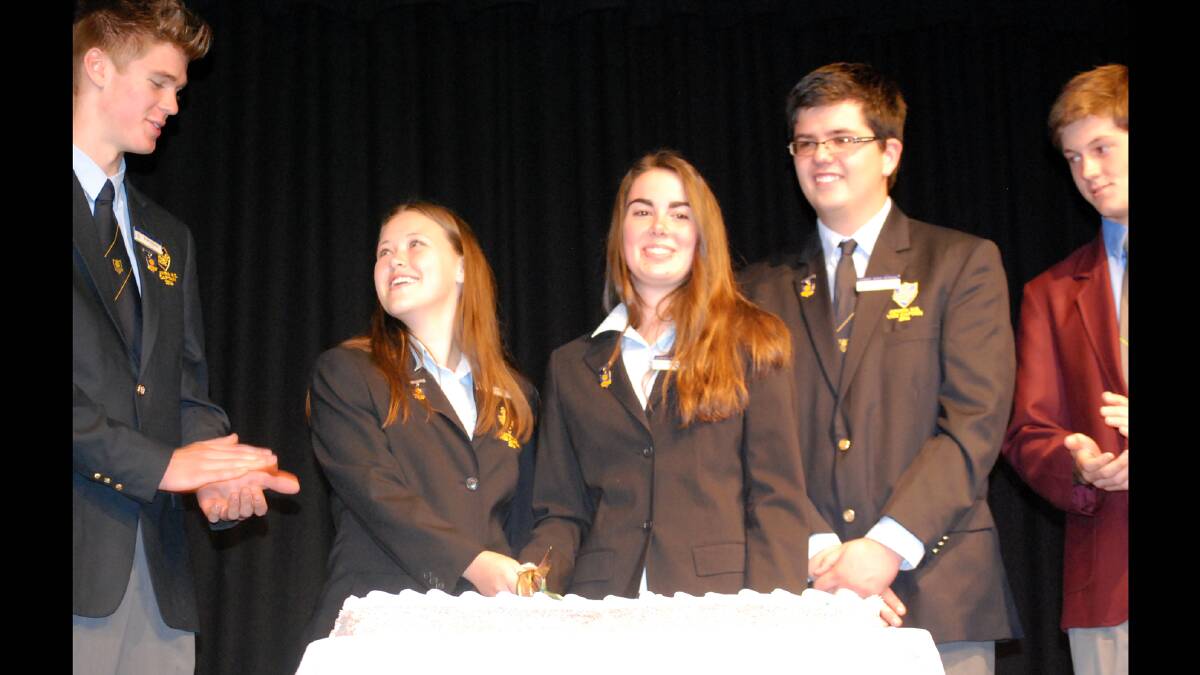 The traditional cutting of the Australia Day cake by the captains of Cowra High school and St Raphael's Central School.